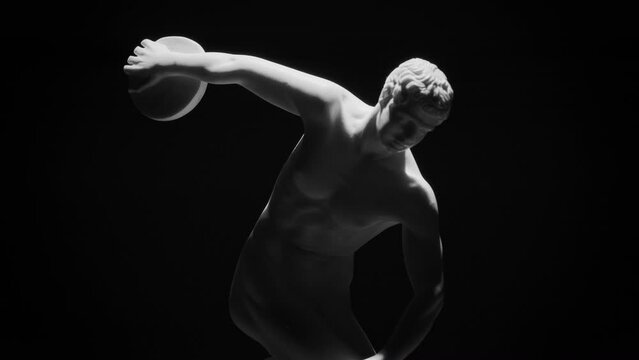 Closeup shot of the Discus Thrower marble sculpture slowly rotating on a black background