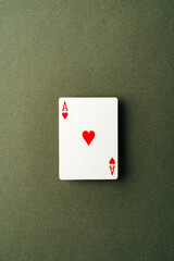 Ace playing card on green background close up