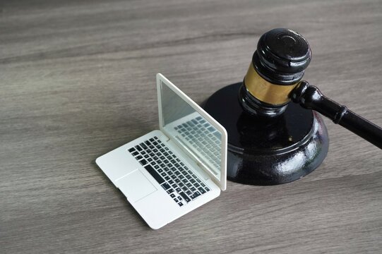 Closeup image of judge gavel and laptop with copy space. Cyber law, computer crime concept.
