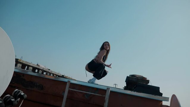A girl in a swimsuit dances sexy on the roof. booty dance, booty shake, Twerk, High Heels, Hip Hop. Beautiful female dancer. Twerking	