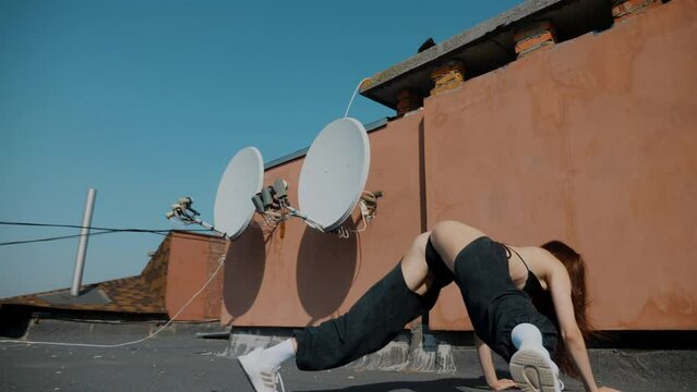 A girl in a swimsuit dances sexy on the roof. booty dance, booty shake, Twerk, High Heels, Hip Hop. Beautiful female dancer. Twerking	