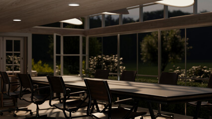 A modern meeting room with glass ceiling and wall, and a green nature outdoor view in the evening.