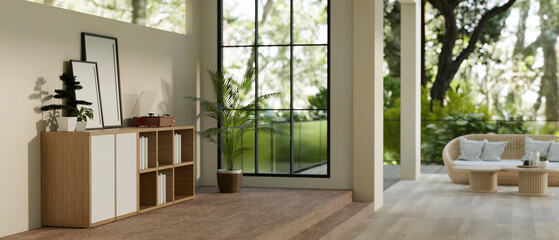 A spacious modern and minimalist living room with a beautiful deck with green nature view.