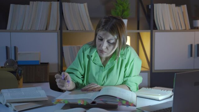 Researcher woman reading a book.