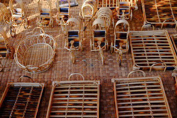 Bamboo made small toys resembling rickshaws, baskets and beds are arranged for sale 