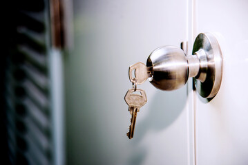 Door handle with keys in hotel room. Selective focus.