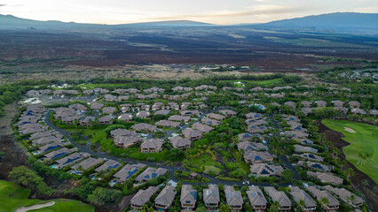 Drone photos over the Kohanaiki Private Club Community on the Big Island, Hawaii. With lush green landscape and luxury housing developments and a beautiful blue ocean