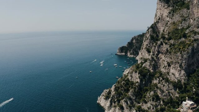 Aerial view of Capri, Italy's steep cliffs leading to lower beaches.