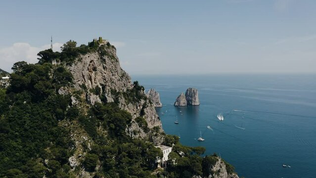 Aerial view orbiting around Capri, Italy's Marina Grande mountain top.