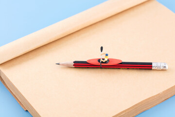 Rowing on an opened kraft paper notebook