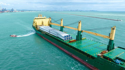 Wind Turbine on Ship, Transportation of blades for wind turbines on a cargo ship. Heavy load...