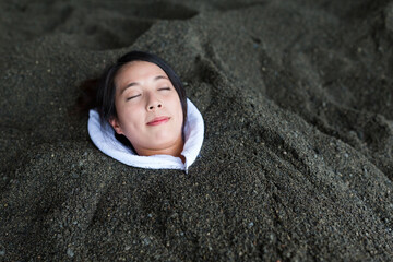 Woman enjoy hot sand bath