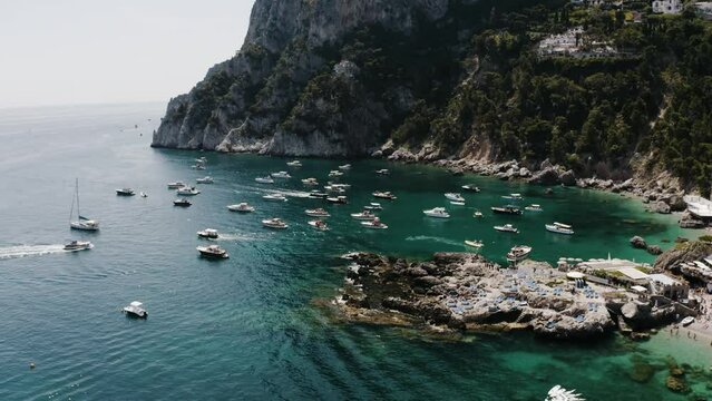Aerial view of Italy's unique coastline filled with boats and tourist resorts.