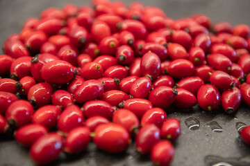 Rose Hip on the kitchen sink. washed red fruits of the rosehip.
