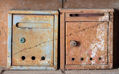 Two old rusted mail boxes.