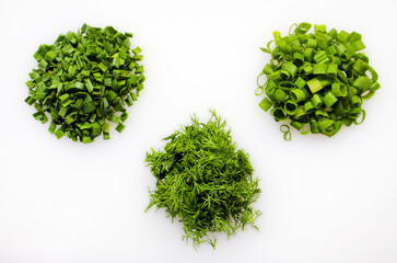 Obraz premium Three varieties of greens are crushed on a white background. Organic farming concept. Cooking concept. Healthy food