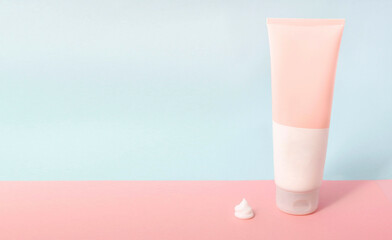 Clean label facial or body cream tube and product squeezed cream texture is isolated on a pink background. Banner for Branding. Cream bottle, lotion, mousse, cleanser, shampoo for skincare routine