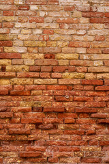 Texture of an old brick wall. Brick walls of Venice. Old red brick clay wall with on a sunny day. Clay brick walls of Italy. italian architecture and heritage