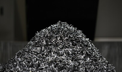 Close-up of pile of metallic shavings made after machinery work on milling or turning lathe for...