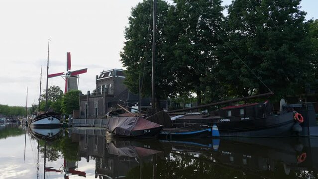 Molen De Roode Leeuw Mill And Old Boats In Gouda, Netherlands - wide
