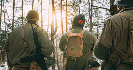 Back View On Re-enactors Dressed As American Infantry Soldier Watch For Bright Sun At Winter Day....