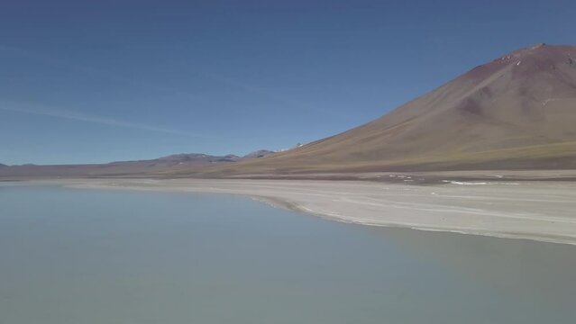 aerial drone shot of the laguna verde and blanca in the arid landscape near volcano Licancabur in the high altitude of the Andes mountains in the highlands of Bolivia.