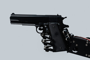 Real robot's hand with handgun. Concept of AI takeover and technological singularity