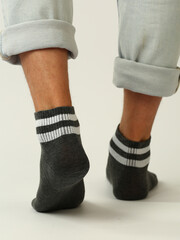 black and white socks with copy space on human feet closeup photo on white background