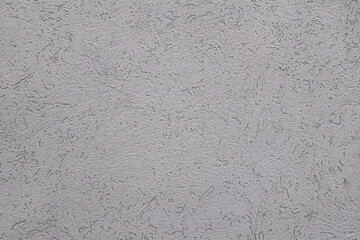 abstract background of embossed concrete wall painted grey close up