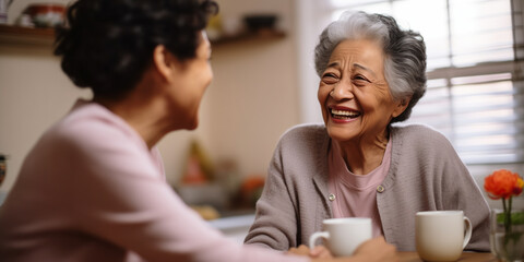 Coffee and Conversations: Ethnic Senior Females Reunite in Kitchen - obrazy, fototapety, plakaty