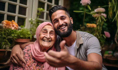 Fototapeta premium Garden Selfies: Pakistani Grandson and Grandmother Snap a Happy Photo