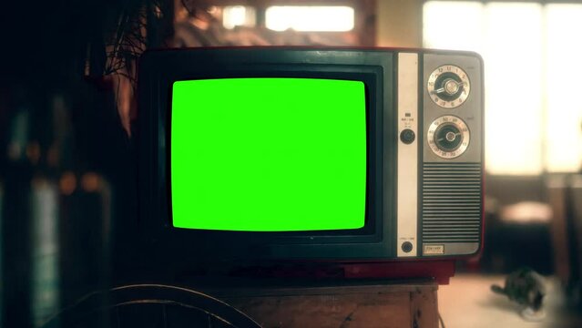 Green Screen Interference TV Vintage Style Zoom In Old Television House Interior. Old vintage television with green screen interference, for replacement, inside of a house. Zoom in