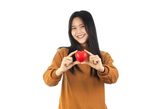 Asian Young Woman holding red heart isolated on white background with clipping path. health insurance, donation, happy charity volunteer concept, world mental health day, world heart day, csv concept