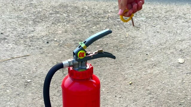 Unsealing a fire extinguisher, close up shot.