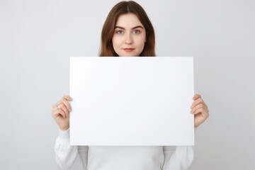 Fototapeta premium Communication in Hand: Woman Holding a White Board for Announcements