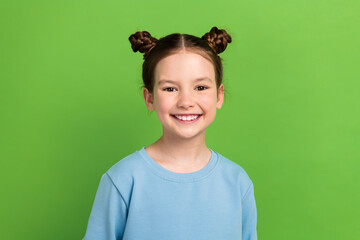 Photo portrait of charming small girl have two funny hair buns demonstrating white teeth isolated...