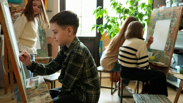 Positive children drawing during an illustration class at an art school