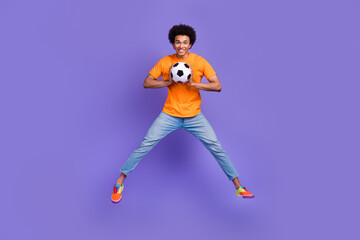 Fototapeta na wymiar Full size body photo of jumping optimistic sportsman student junior team football player goalkeeper isolated on violet color background