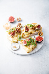 Baked camembert cheese with figs and honey on toast
