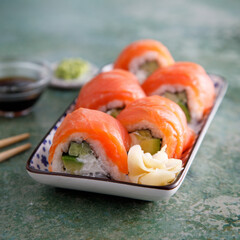Salmon sushi rolls with cucumber and avocado