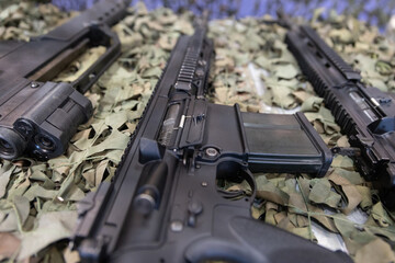 Laid out weapons on camouflage.