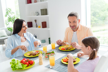 Photo of cheerful idyllic people good mood enjoy eat tasty food together kitchen table apartment inside