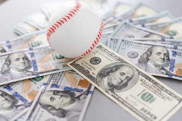 Baseball ball with cash money. Major league strike, lockout and sports betting concept. - obrazy, fototapety, plakaty