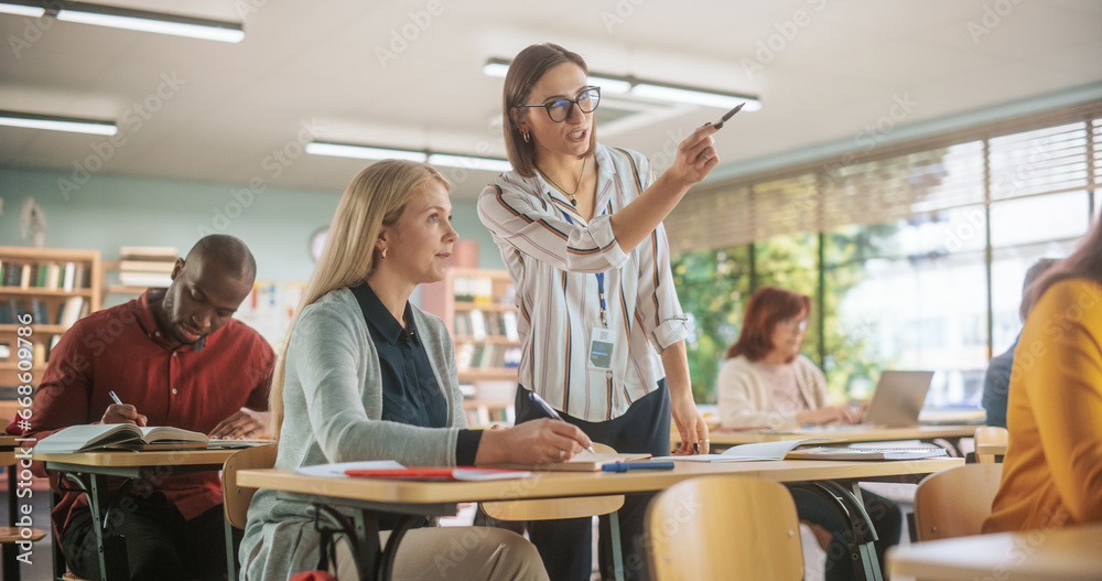 Poster helpful young teacher talking with a middle aged female, helping to find a solution for a test cours