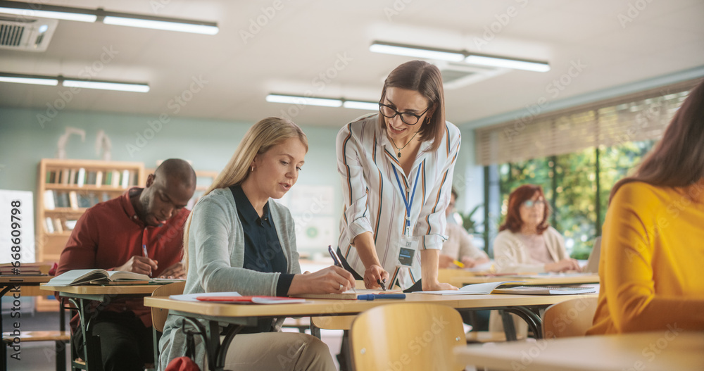Poster helpful young teacher talking with a middle-aged female, helping to find a solution for a test cours