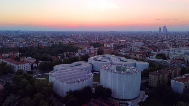 Aerial view of solar panels on the roof. The new campus of the SDA Bocconi School of Management is a modern building with classrooms. Colorful sky at sunset. Ecological energy. Milan Italy 17.11.2023