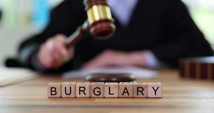 Text burglary and judge banging gavel in court. Arbitrator issues verdict in robbery and official punishment for illegal actions