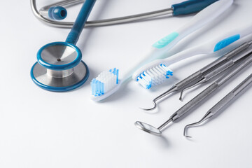 Dental tools and toothbrush on white background