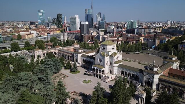 Aerial view of the Cimitero Monumentale cemetery. The cemetery is famous for tombstones in various styles, as well as the graves of famous artists and architects. Skyline with skyscrapers. Milan Italy
