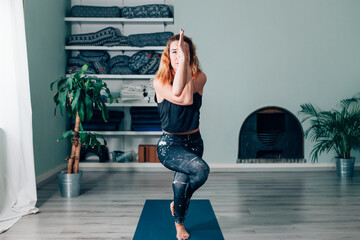 yogic woman practicing in yoga studio